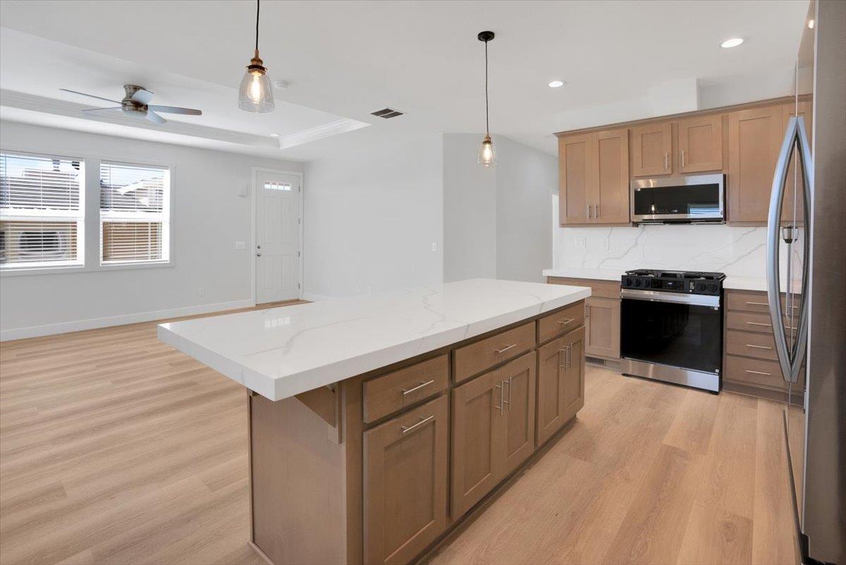 144 Holm Road, Unit 55 Watsonville, CA 95076 - Photo 8 of 24 a kitchen with a sink a microwave and refrigerator