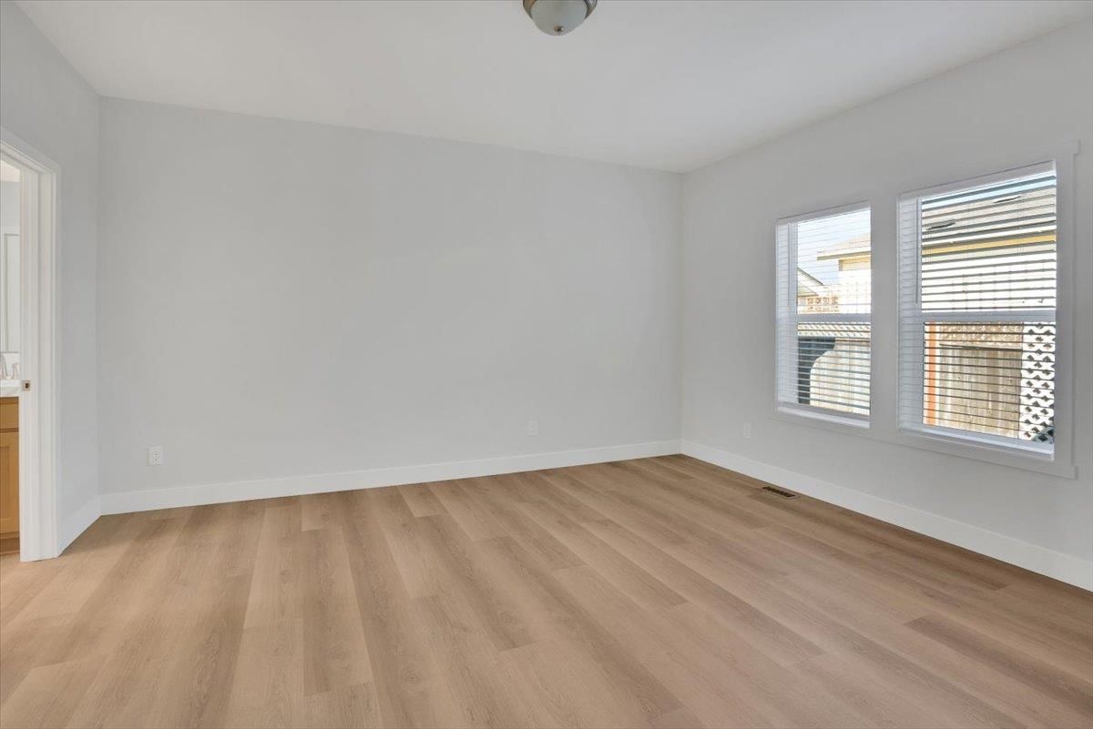 144 Holm Road, Unit 55 Watsonville, CA 95076 - Photo 10 of 24 wooden floor in an empty room with a window
