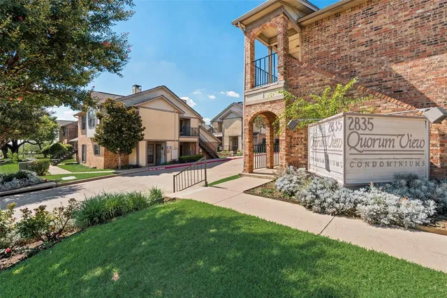 a front view of a house with a yard and an tree