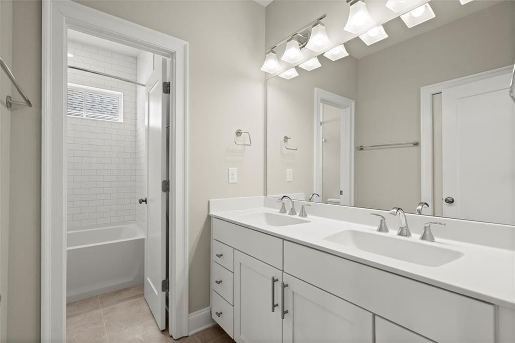 293 Thompson Street Alpharetta, GA 30009 - Photo 40 of 71 a bathroom with double vanity sink a vanity and a mirror