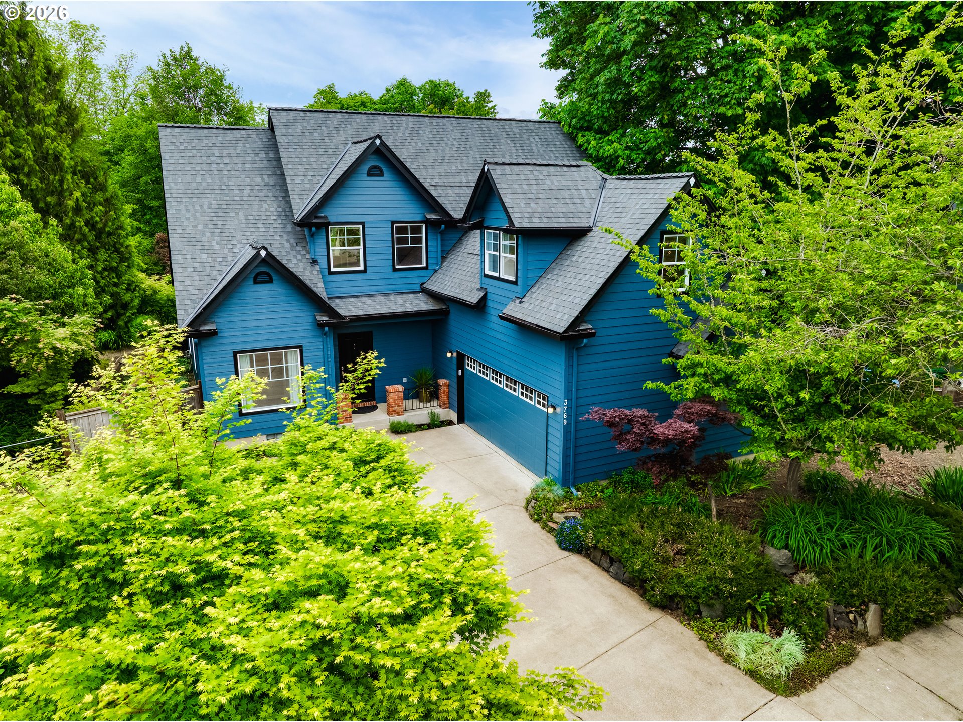 3769 Julia Loop Eugene, OR 97404 - Photo 1 of 46 a front view of a house with a yard and potted plants