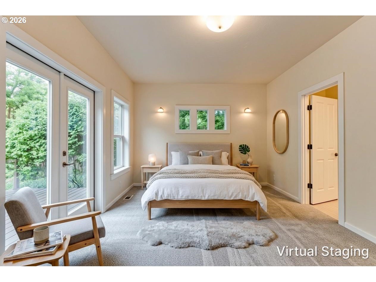 3769 Julia Loop Eugene, OR 97404 - Photo 15 of 46 a spacious bedroom with a bed a table and windows