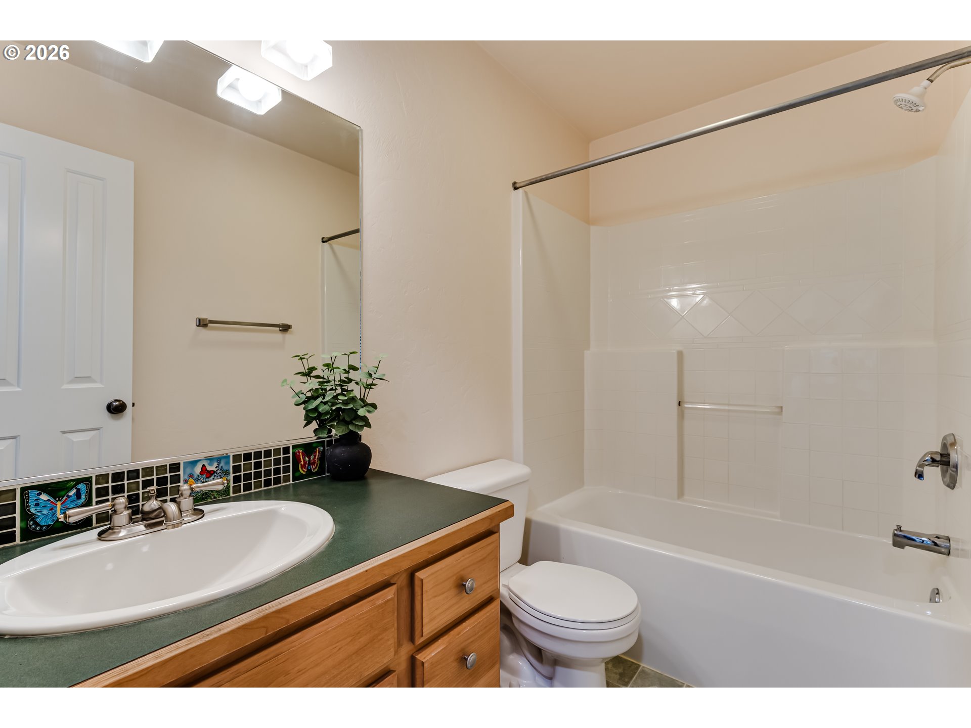 3769 Julia Loop Eugene, OR 97404 - Photo 30 of 46 a bathroom with a granite countertop sink a toilet a mirror a bathtub and shower