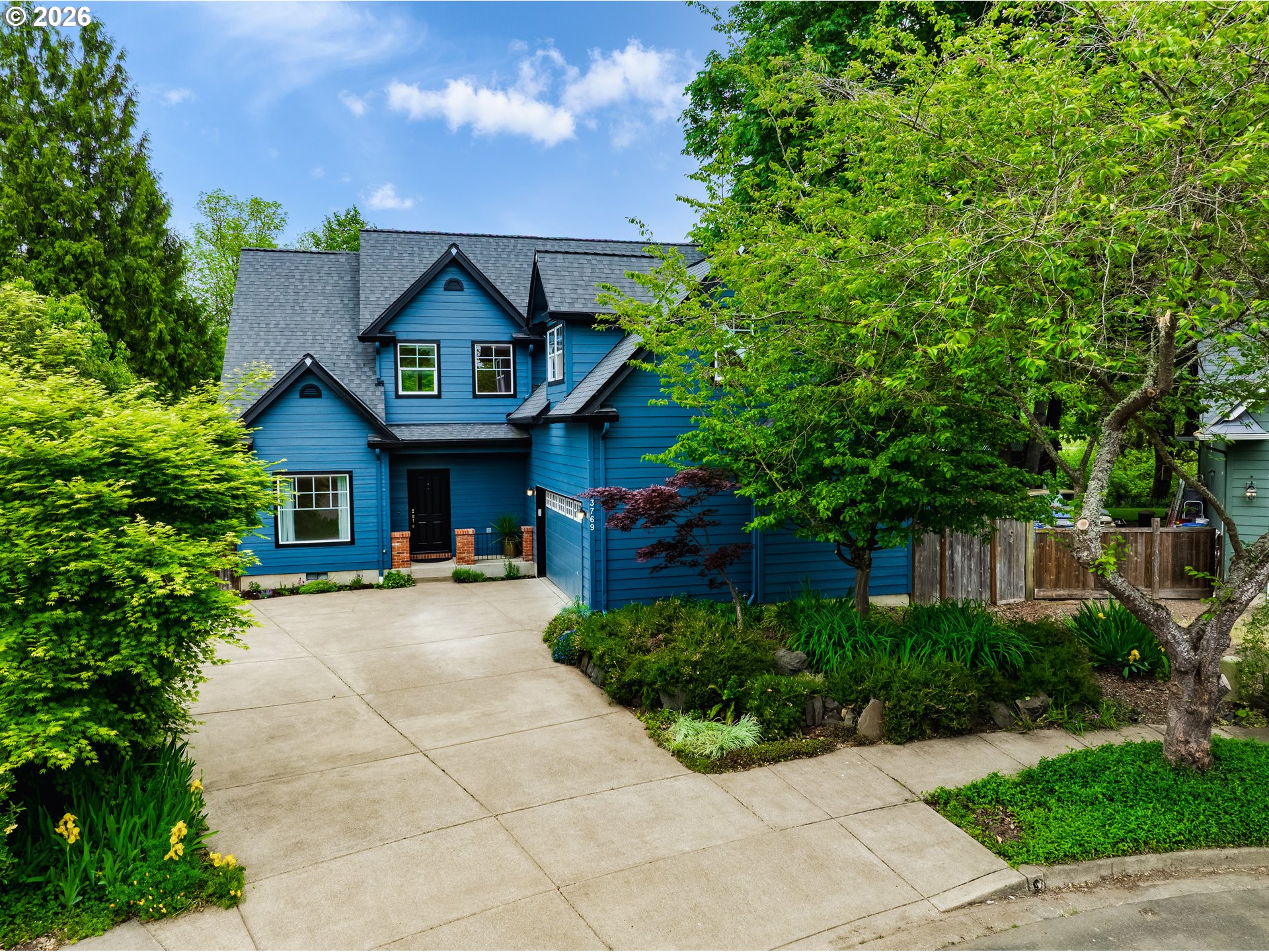 3769 Julia Loop Eugene, OR 97404 - Photo 3 of 46 a view of a house with a small yard plants and large tree
