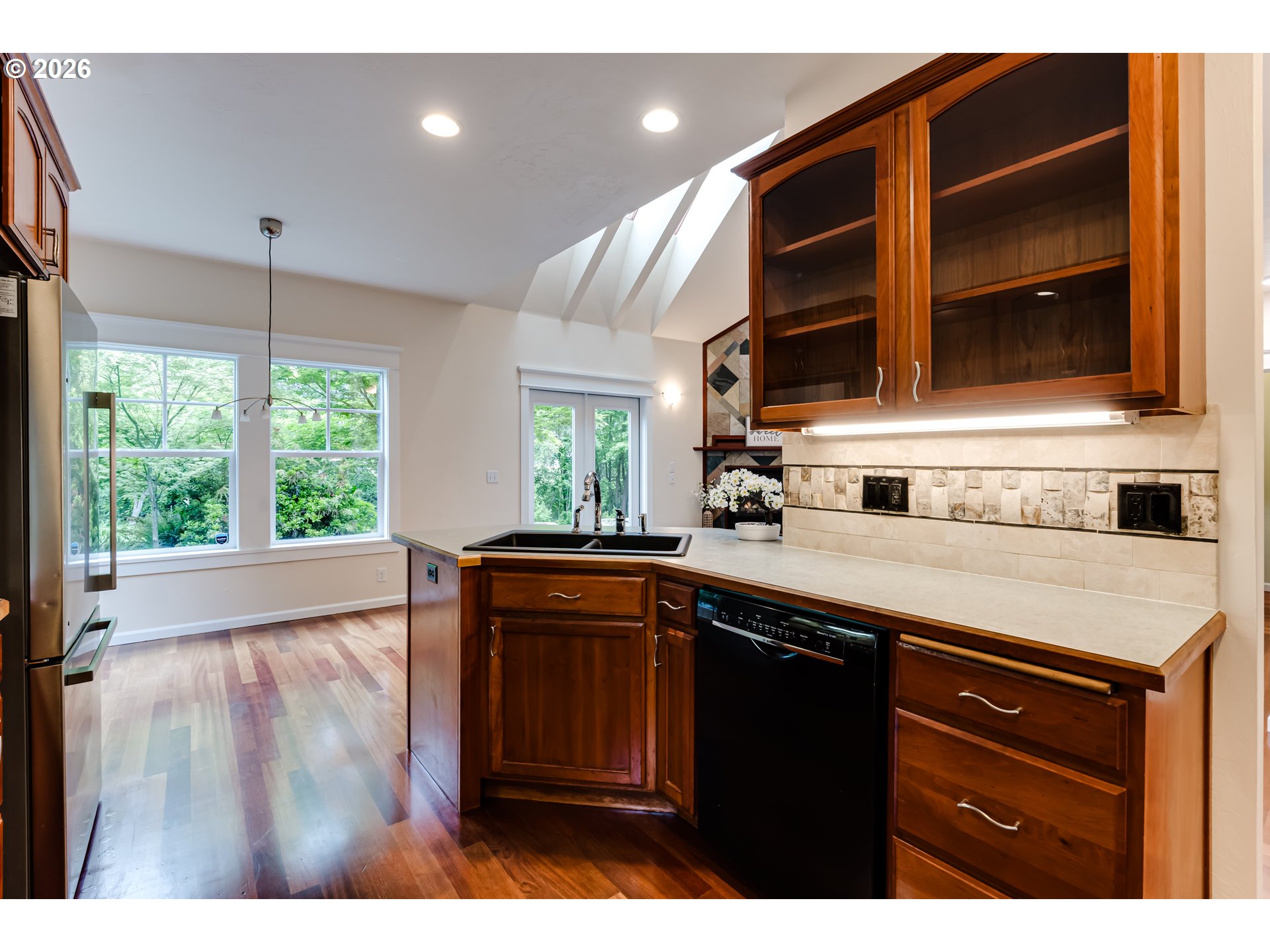 3769 Julia Loop Eugene, OR 97404 - Photo 10 of 46 a kitchen with stainless steel appliances granite countertop wooden cabinets a oven a stove and a large window