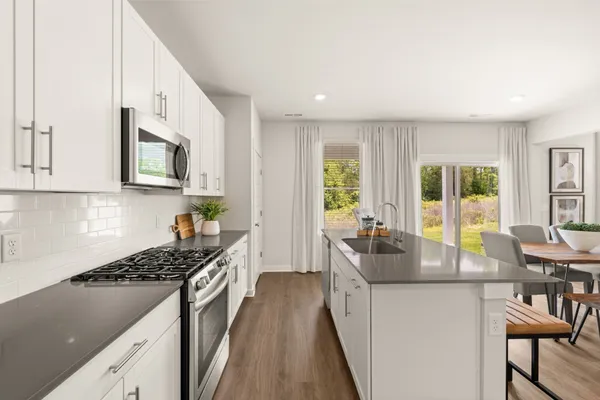 a view of kitchen with white cabinets