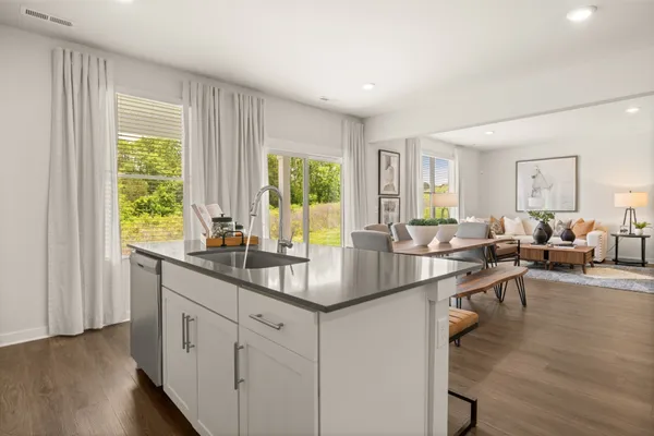 a view of a bedroom with a bed and wooden floor
