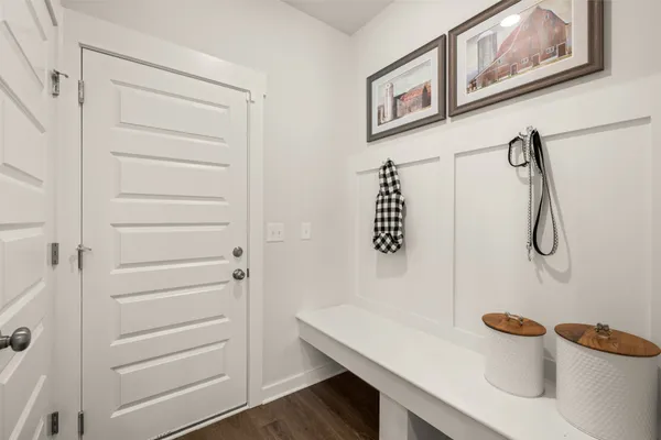a bedroom with a bed and painting on the wall