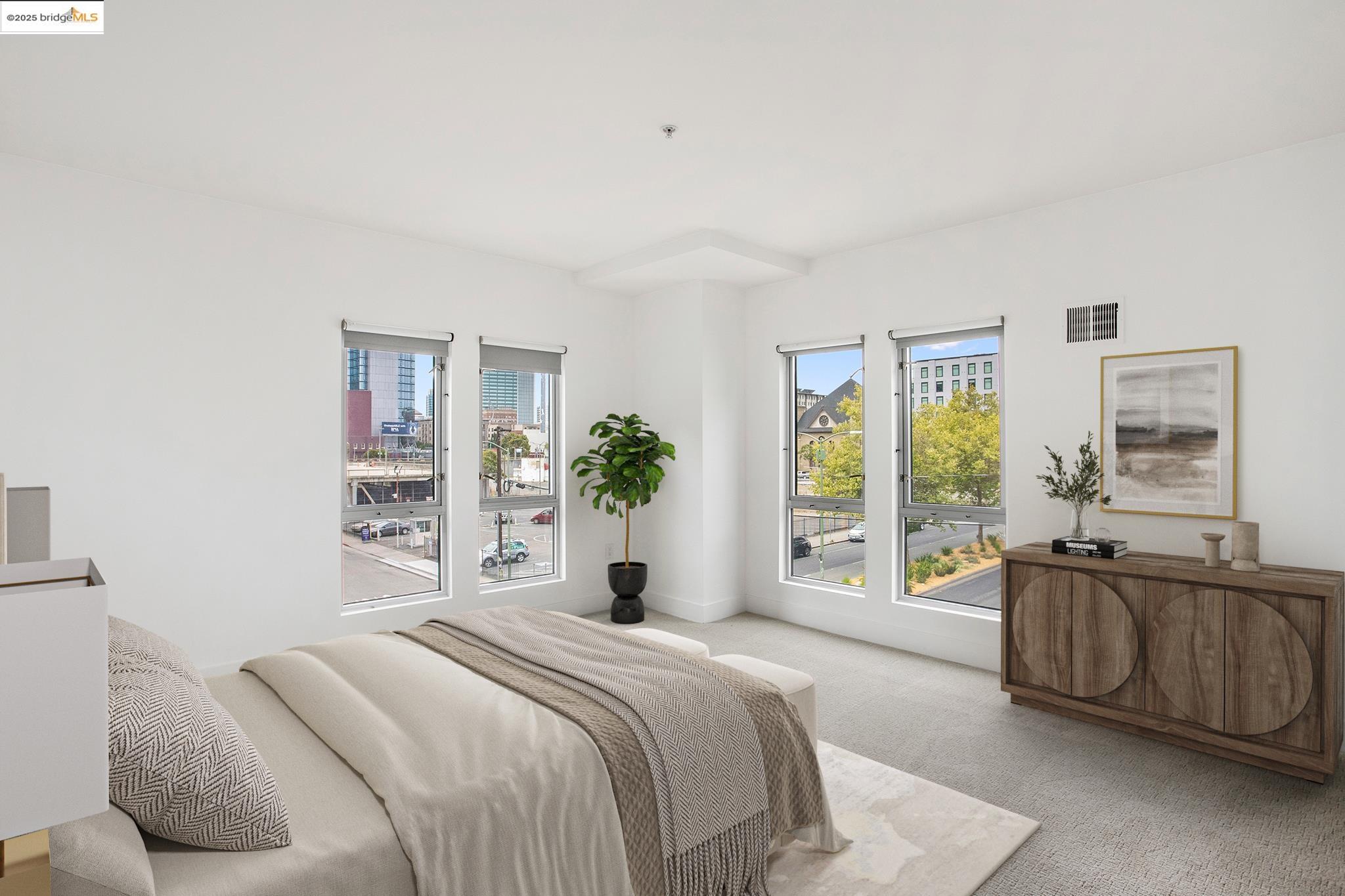 438 West Grand Avenue, Unit 401 Oakland, CA 94612 - Photo 13 of 30 a bedroom with a bed and a large window