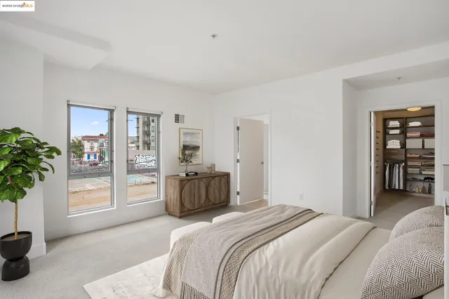 a bedroom with a bed and a large window