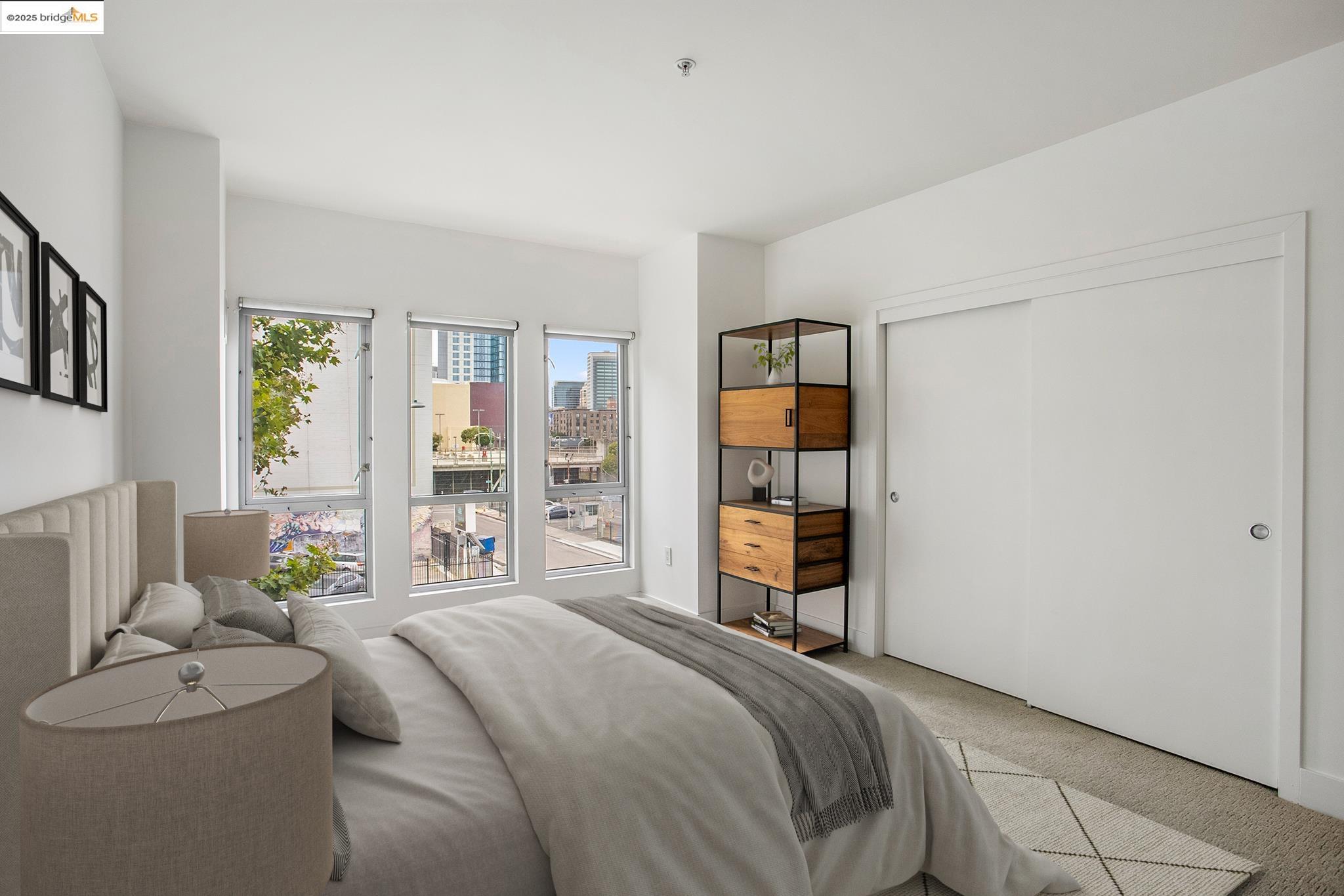 438 West Grand Avenue, Unit 401 Oakland, CA 94612 - Photo 16 of 30 a bedroom with a bed and a cabinets