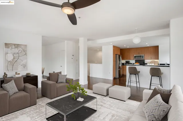 a living room with furniture kitchen view and a table