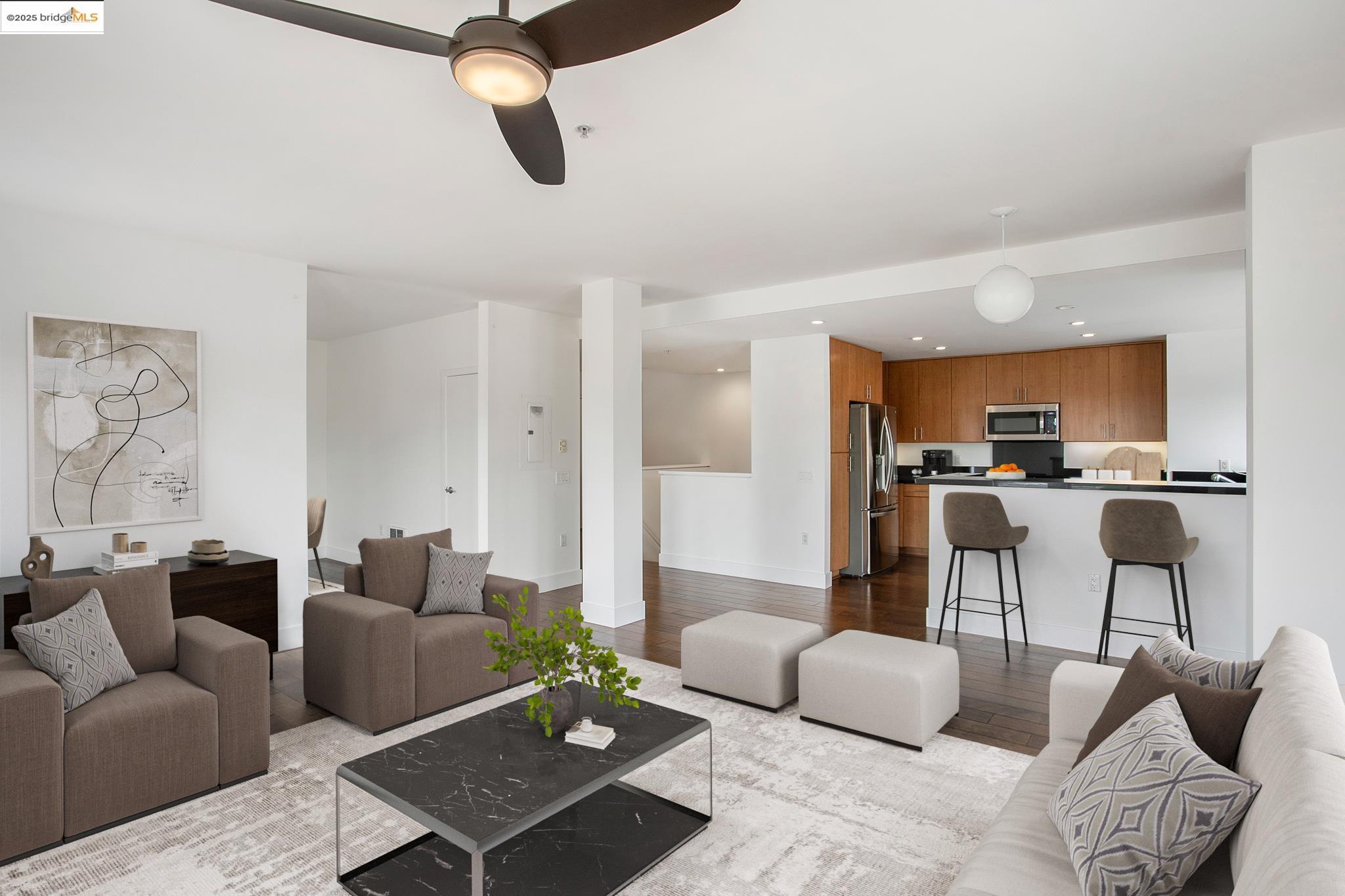 438 West Grand Avenue, Unit 401 Oakland, CA 94612 - Photo 2 of 30 a living room with furniture kitchen view and a table
