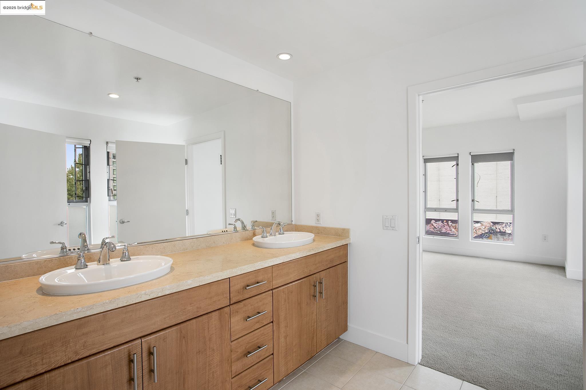 438 West Grand Avenue, Unit 401 Oakland, CA 94612 - Photo 21 of 30 a bathroom with a sink and a mirror