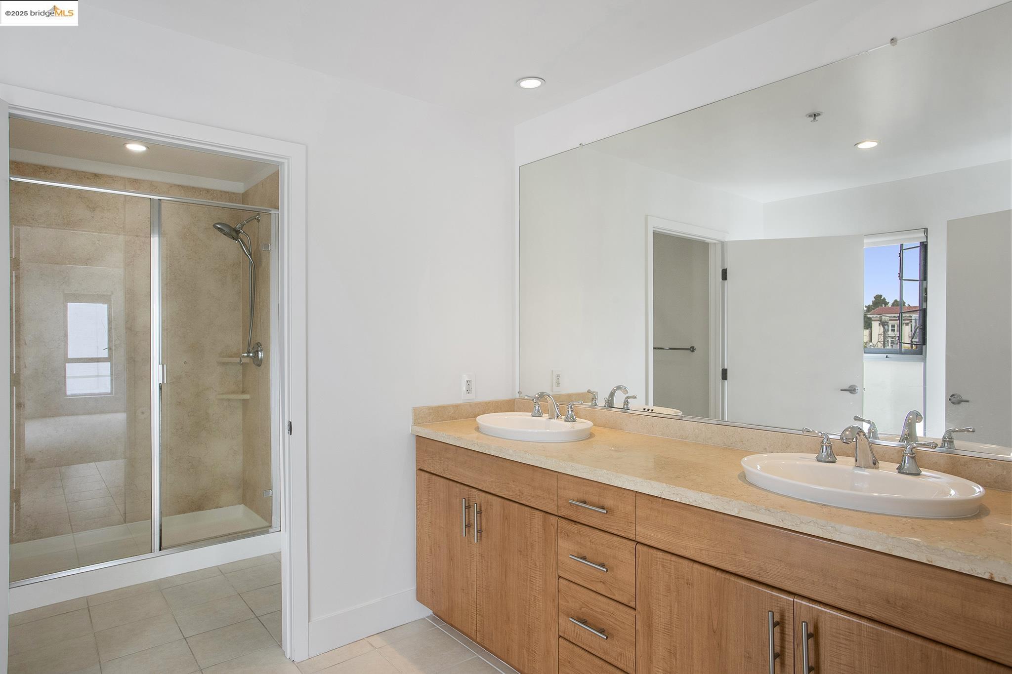 438 West Grand Avenue, Unit 401 Oakland, CA 94612 - Photo 22 of 30 a bathroom with a sink double vanity and a mirror