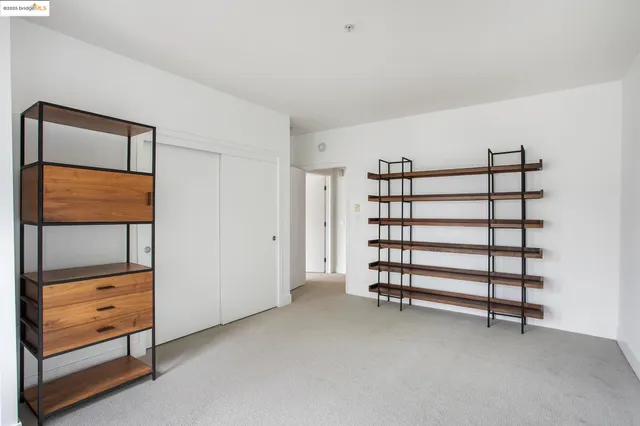 an empty room with windows and closet