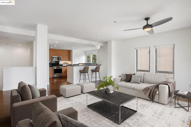 a living room with furniture and view of kitchen