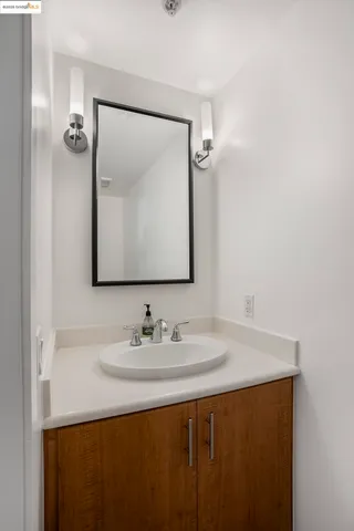 a bathroom with a sink vanity and a mirror