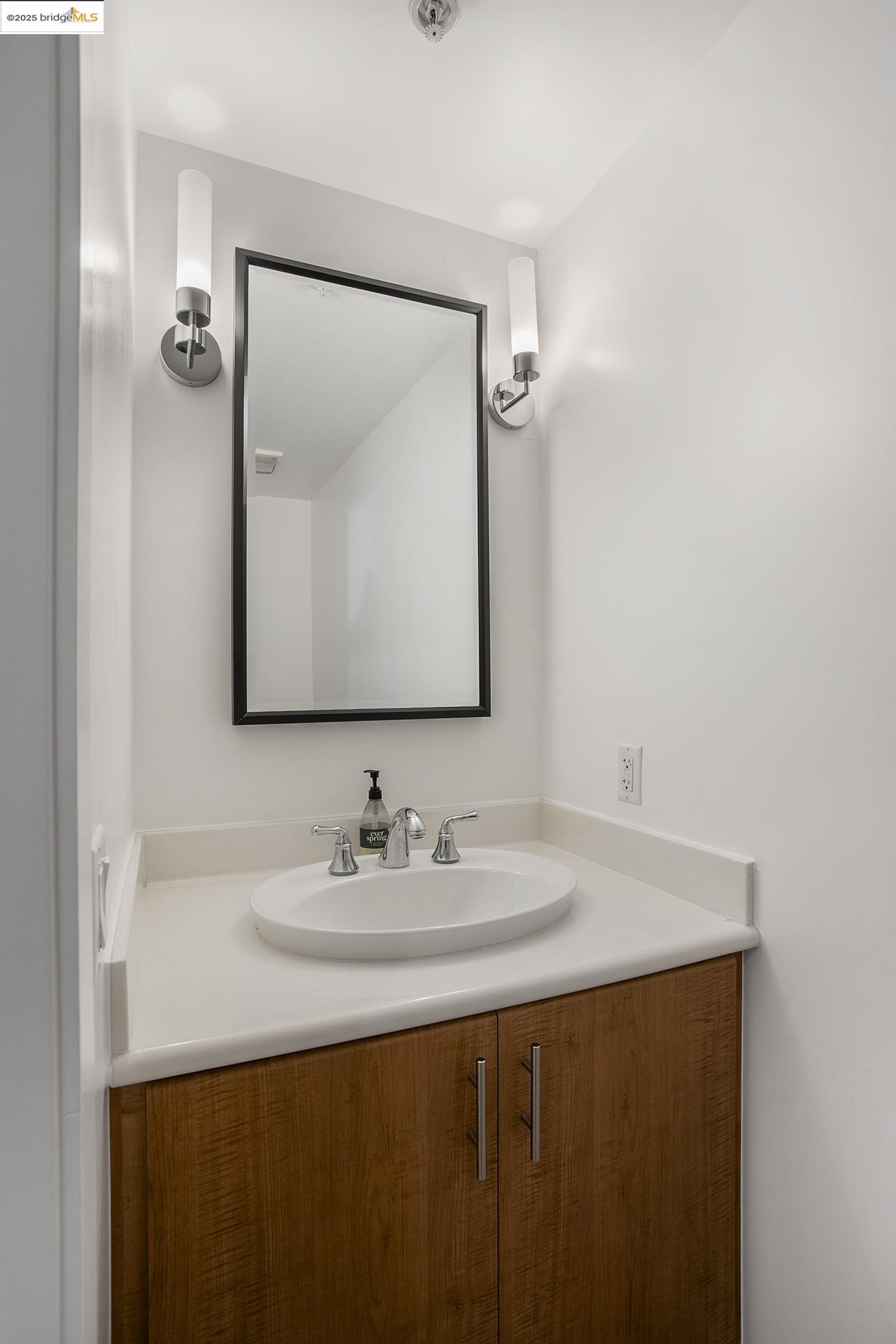438 West Grand Avenue, Unit 401 Oakland, CA 94612 - Photo 6 of 30 a bathroom with a sink vanity and a mirror