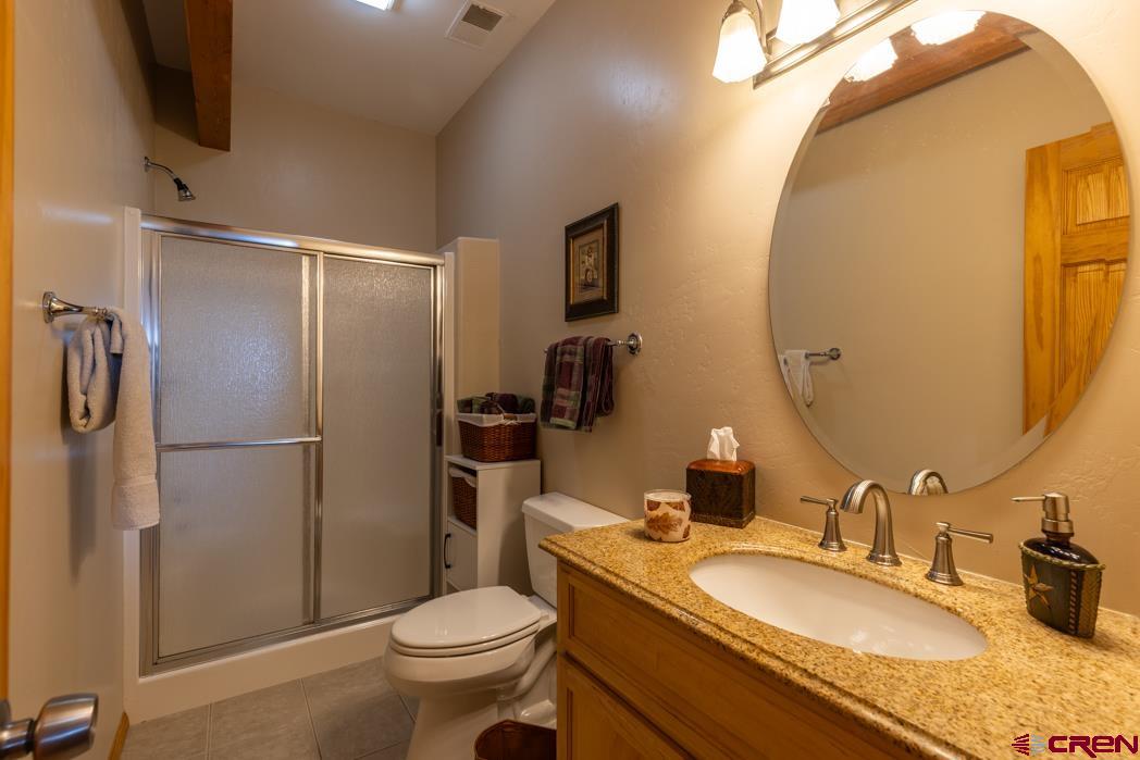 1737 Roberts Ridge Drive Hesperus, CO 81326 - Photo 23 of 34 a bathroom with a granite countertop sink toilet and shower