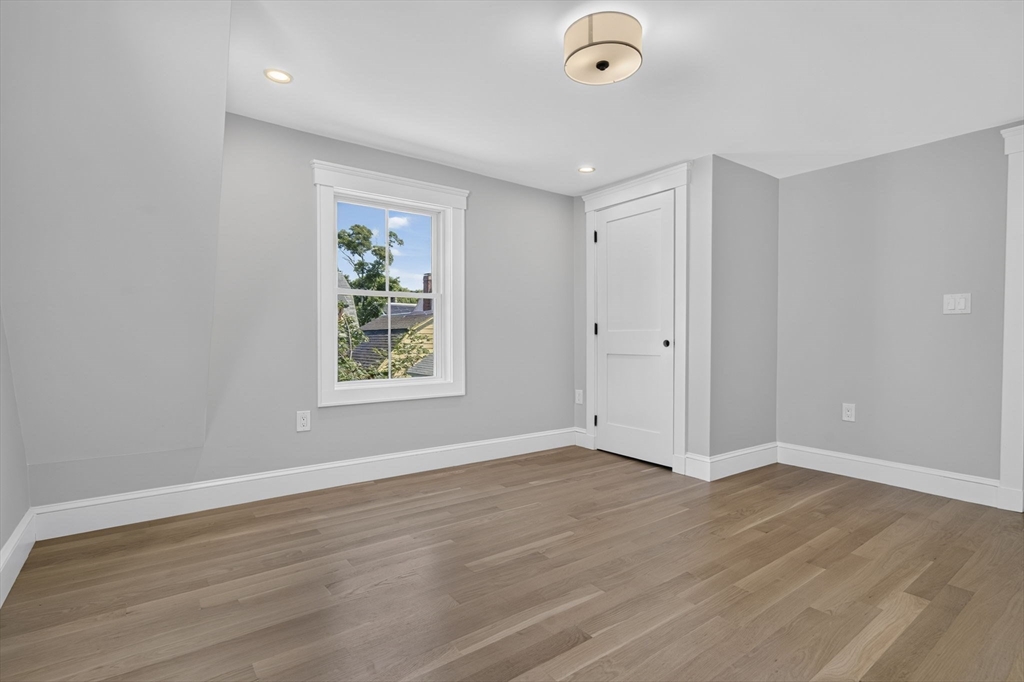 20 Saltonstall Road Medford, MA 02155 - Photo 30 of 41 a view of an empty room with wooden floor and a window