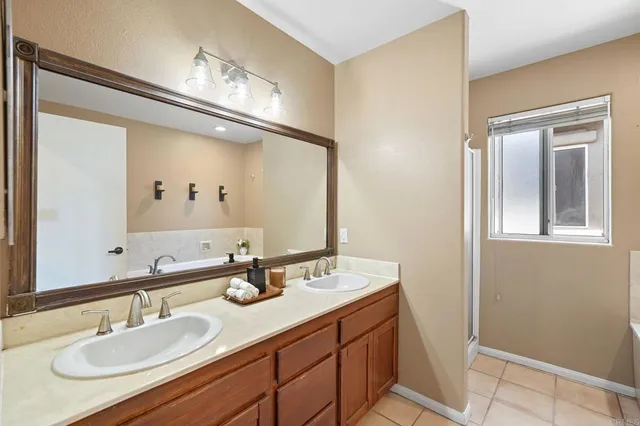 a bathroom with a granite countertop toilet sink and mirror