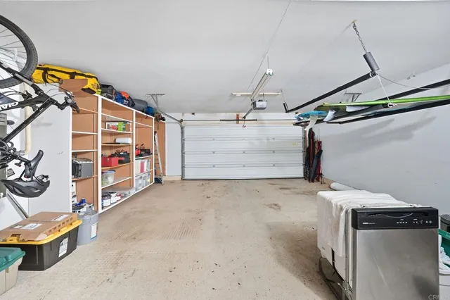 a kitchen with stainless steel appliances a sink a stove a refrigerator and cabinets
