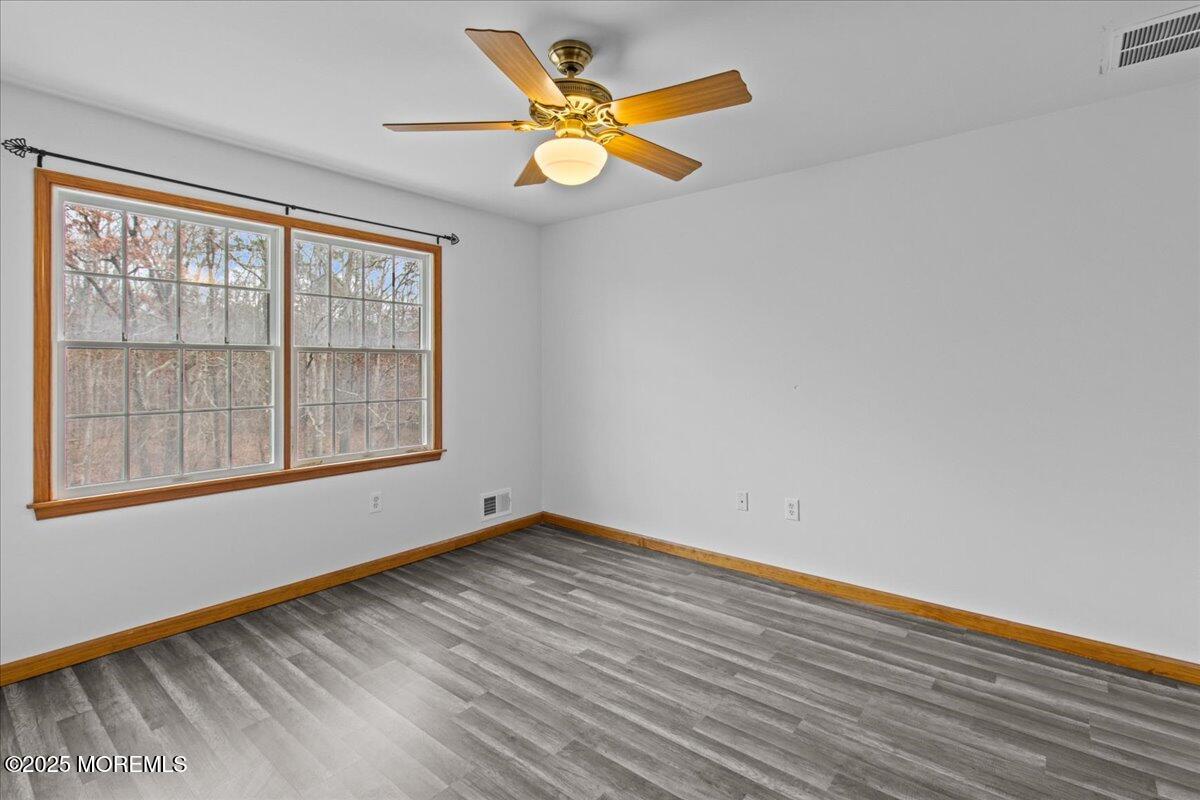 73 Porter Road Howell, NJ 07731 - Photo 16 of 65 wooden floor in an empty room with a window