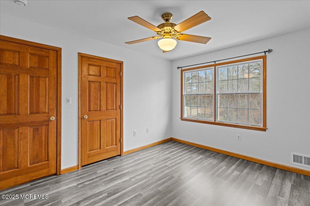 73 Porter Road Howell, NJ 07731 - Photo 17 of 65 a view of an empty room with wooden floor and a window