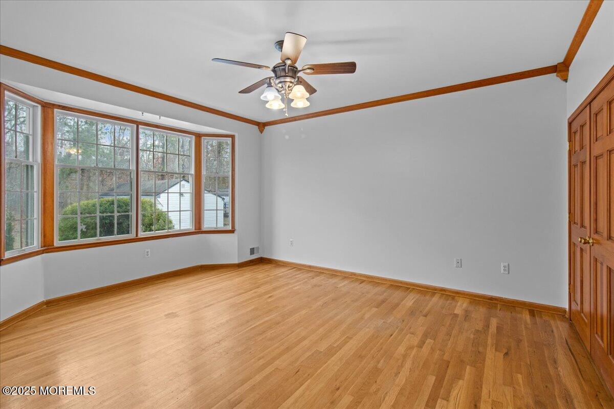 73 Porter Road Howell, NJ 07731 - Photo 28 of 65 a view of an empty room with a window and wooden floor