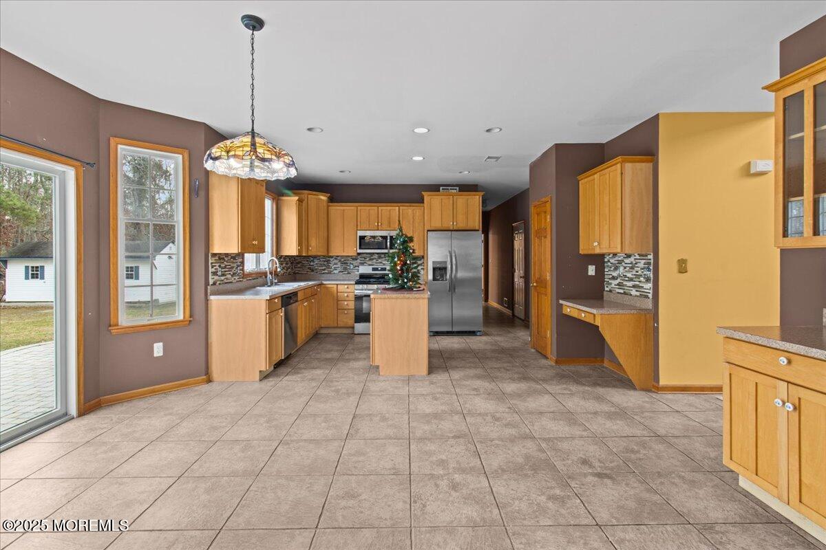 73 Porter Road Howell, NJ 07731 - Photo 52 of 65 a large kitchen with granite countertop a stove a sink a refrigerator and a granite counter top