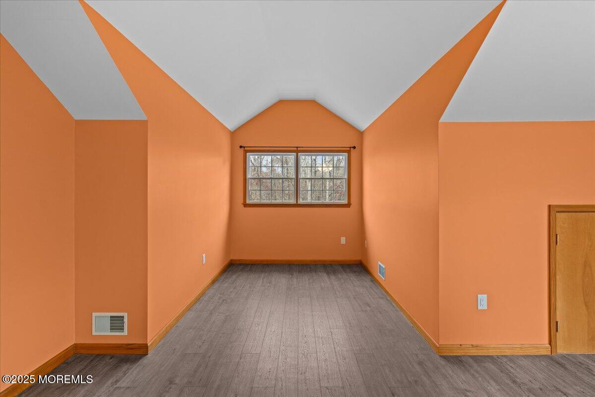 73 Porter Road Howell, NJ 07731 - Photo 8 of 65 a view of a room with wooden floor a ceiling fan and windows