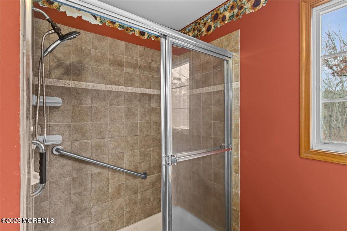 73 Porter Road Howell, NJ 07731 - Photo 10 of 65 a bathroom with a glass shower door