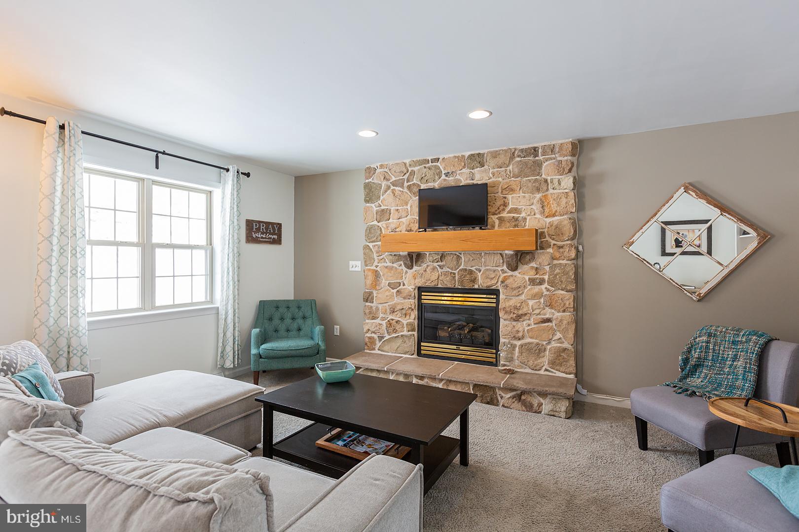 2249 Spring Valley Road Lancaster, PA 17601 - Photo 11 of 75 a living room with furniture a window and a fireplace