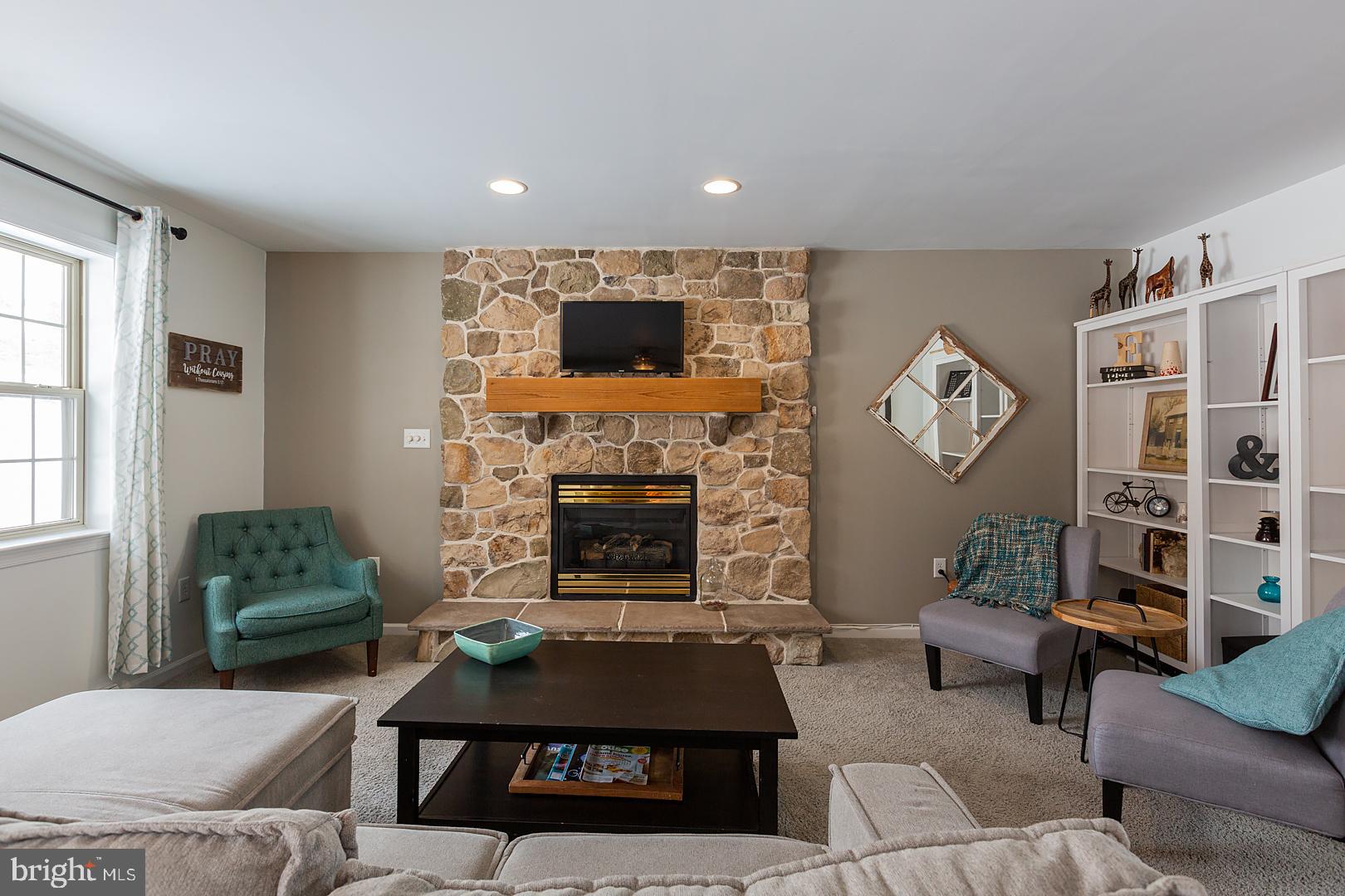 2249 Spring Valley Road Lancaster, PA 17601 - Photo 12 of 75 a living room with furniture and a fireplace