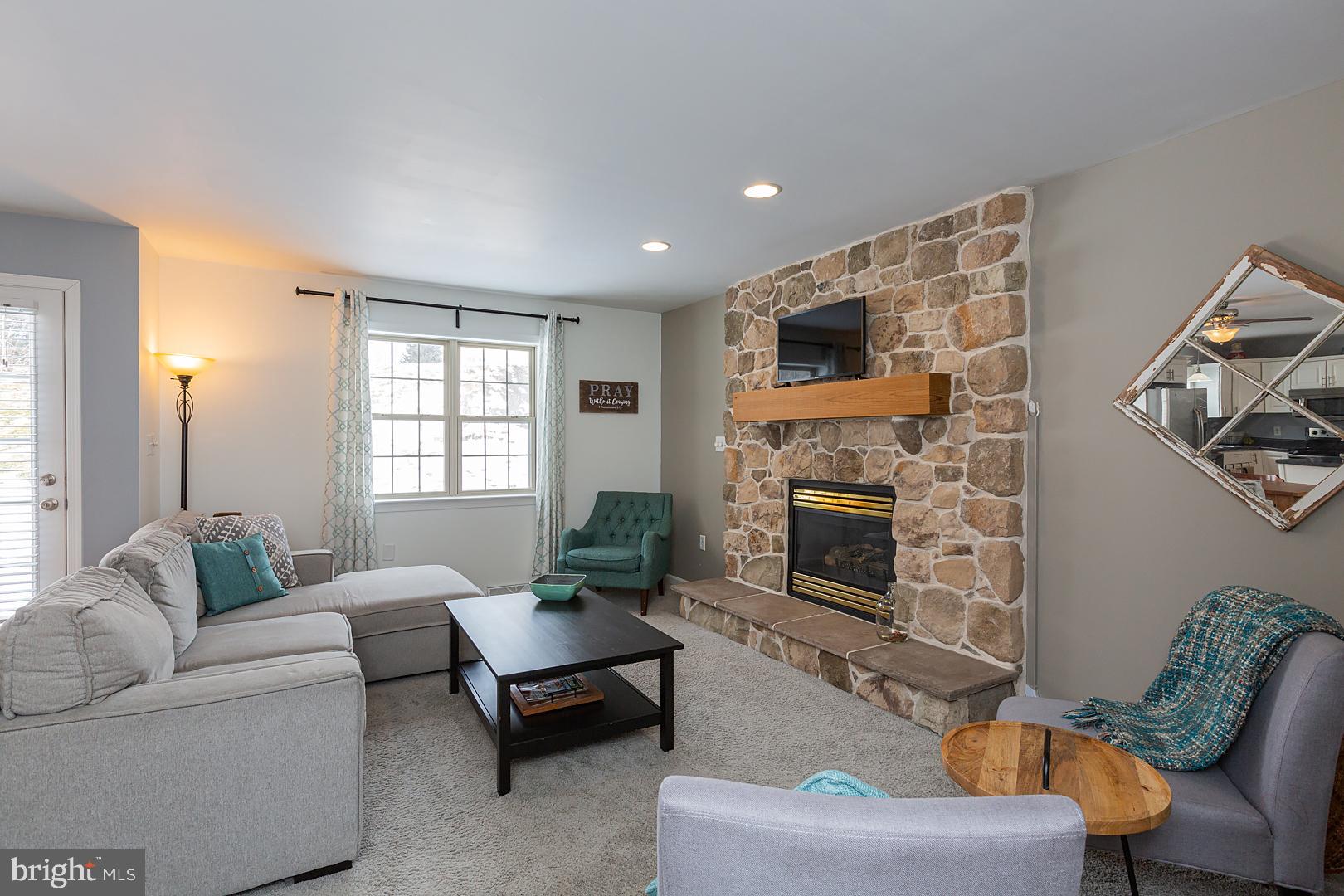 2249 Spring Valley Road Lancaster, PA 17601 - Photo 14 of 75 a living room with furniture and a fireplace