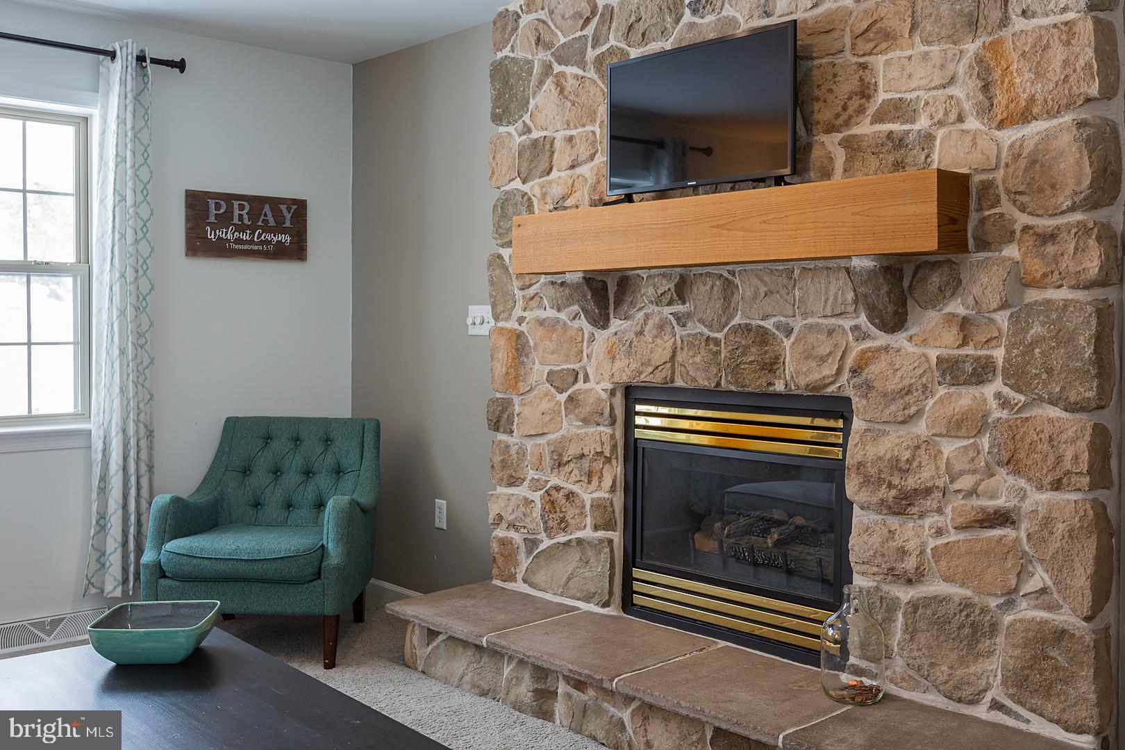 2249 Spring Valley Road Lancaster, PA 17601 - Photo 15 of 75 a living room with furniture and a fireplace