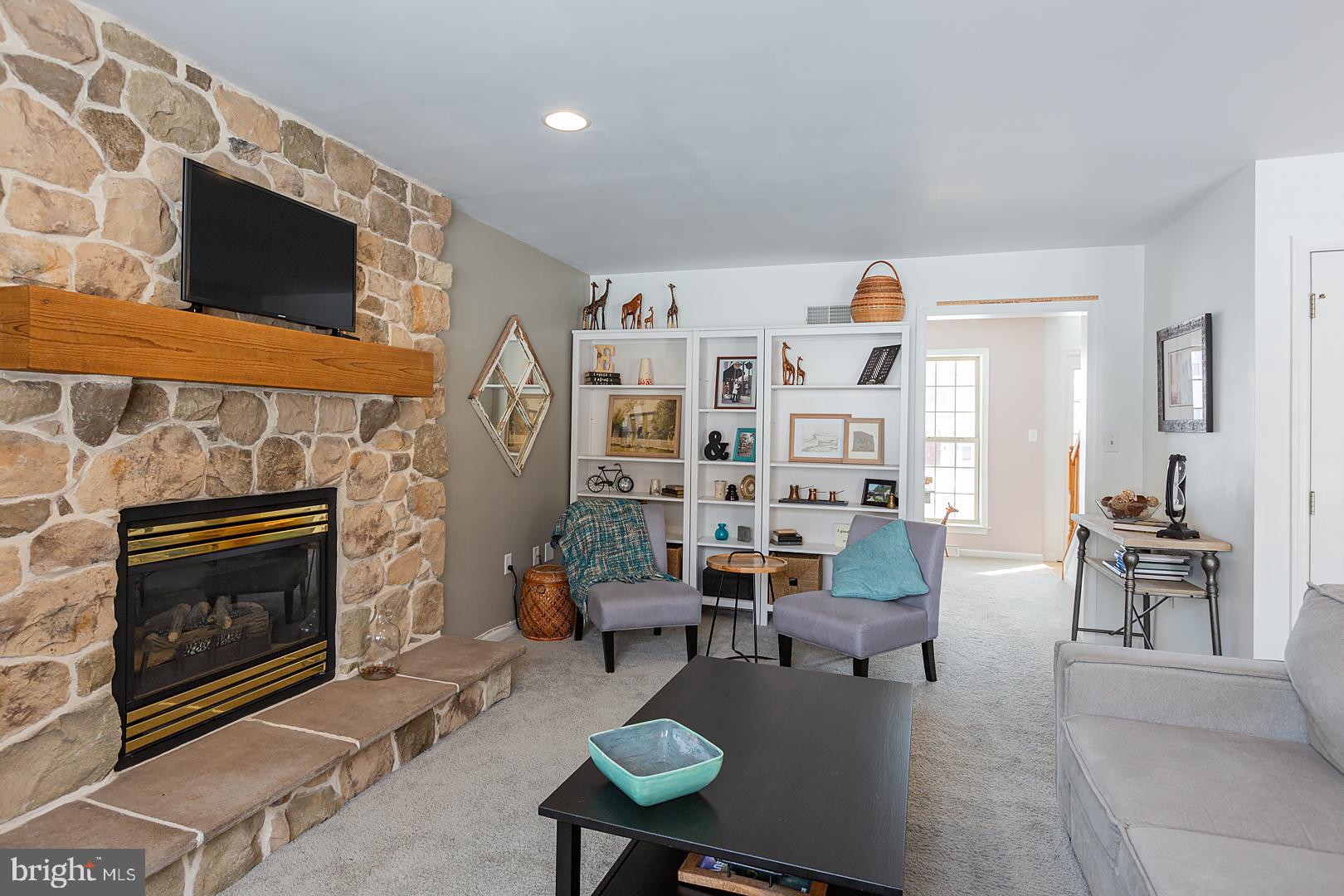 2249 Spring Valley Road Lancaster, PA 17601 - Photo 18 of 75 a living room with furniture a flat screen tv and a fireplace