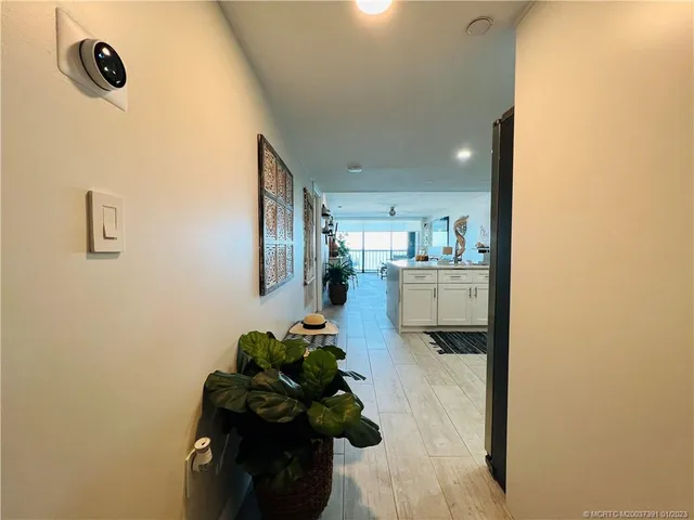 a large white kitchen with stainless steel appliances granite countertop a refrigerator and a sink