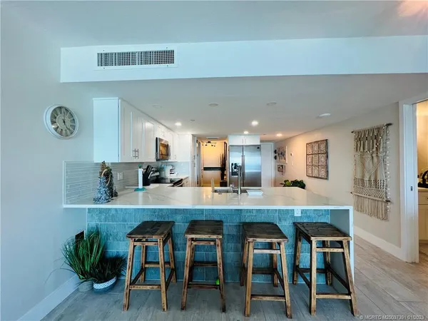 a kitchen with cabinets appliances and a counter space