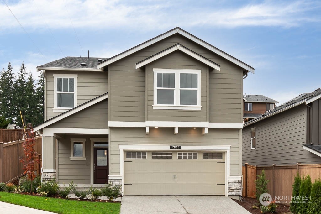 4419 228th Place South East, Unit MC18 Bothell, WA 98021 - Photo 1 of 35 a front view of a house with garden