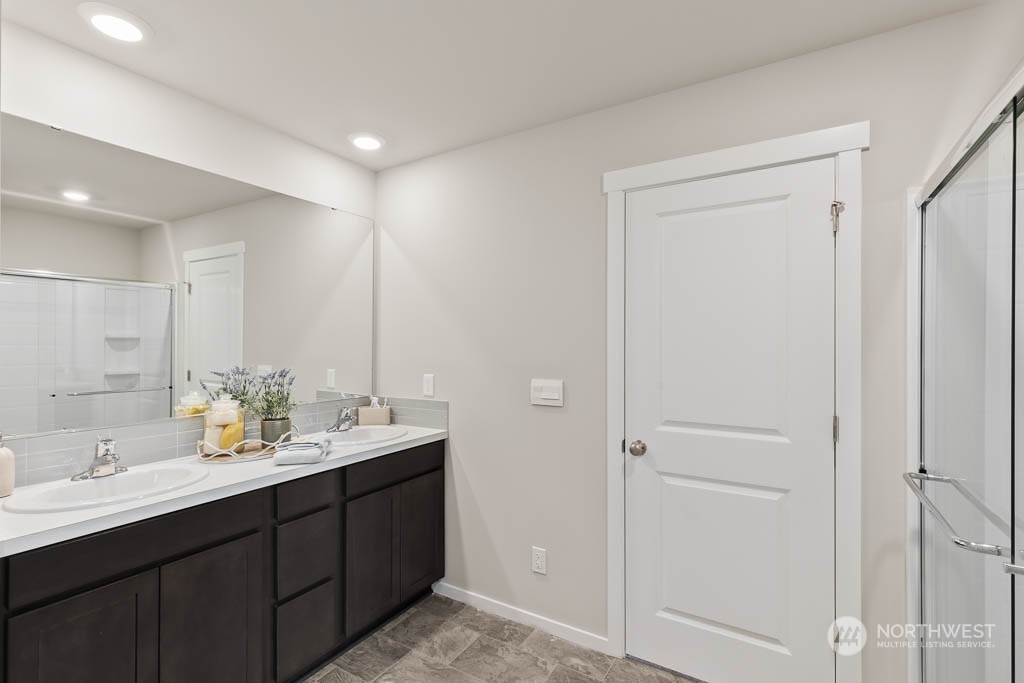 4419 228th Place South East, Unit MC18 Bothell, WA 98021 - Photo 23 of 35 a bathroom with double vanity sinks and a mirror