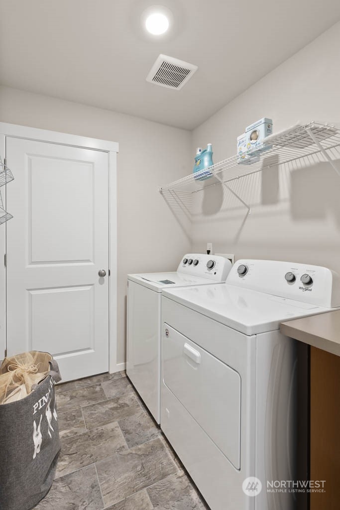 4419 228th Place South East, Unit MC18 Bothell, WA 98021 - Photo 26 of 35 a utility room with cabinets washer and dryer