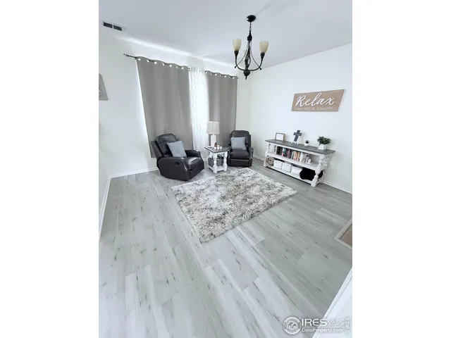 a view of a living room with furniture and a window