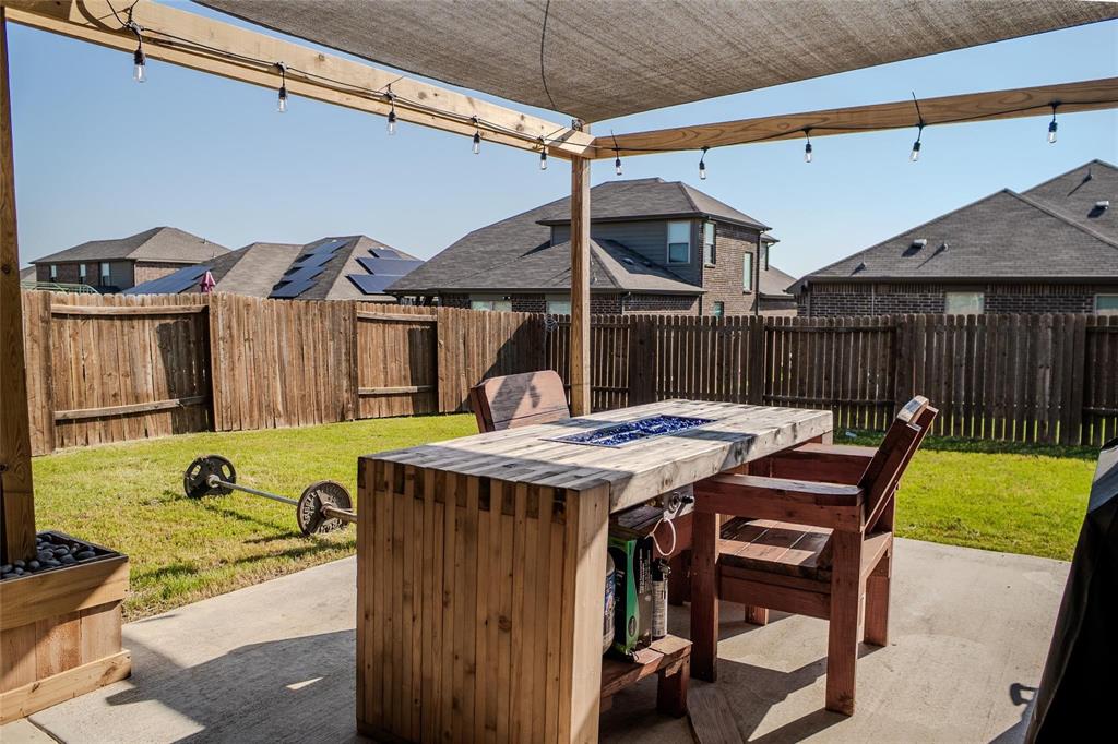 1837 Rialto Lane Crowley, TX 76036 - Photo 6 of 24 Expansive concrete patio featuring a shade canopy with string lighting