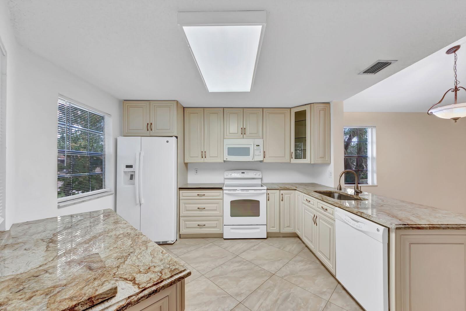 a kitchen with a stove a sink and a refrigerator