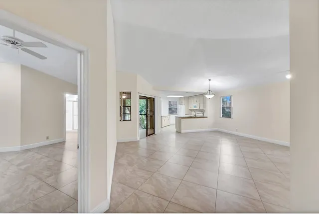 a view of a livingroom with a ceiling fan and a large window