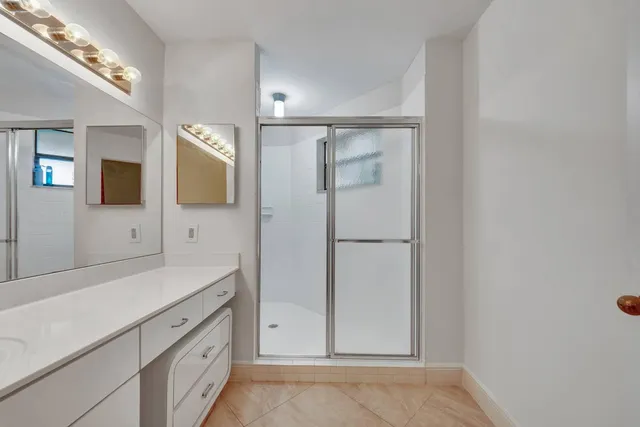 a spacious bathroom with a double vanity sink and mirror
