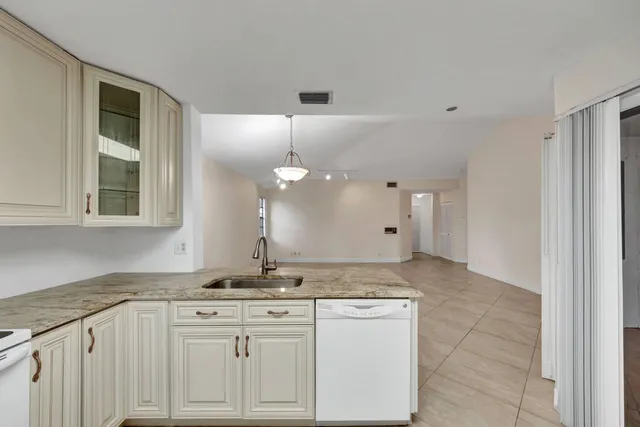a kitchen with granite countertop a stove and a sink