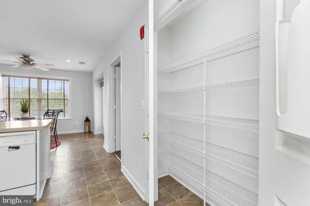 a kitchen with white cabinets and sink
